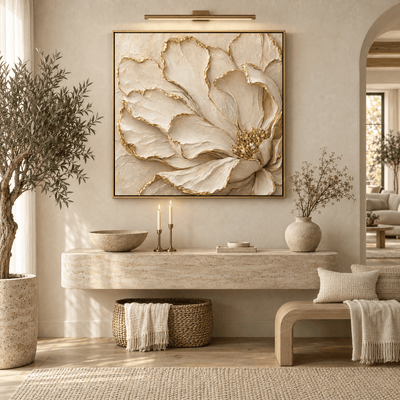 Luxury cream and gold flower wall art hanging above a travertine entryway console