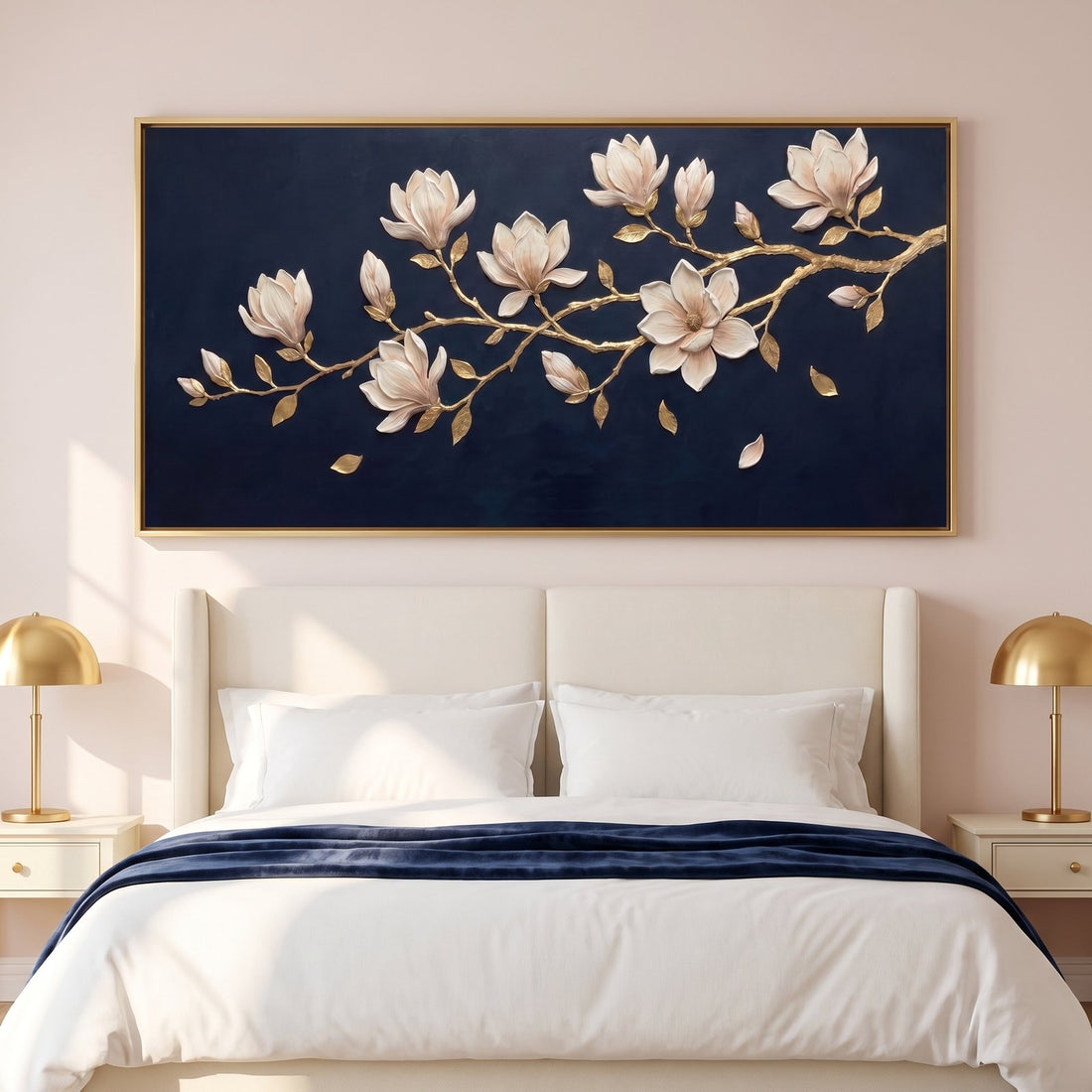 Navy magnolia wall art above an ivory headboard in a blush bedroom