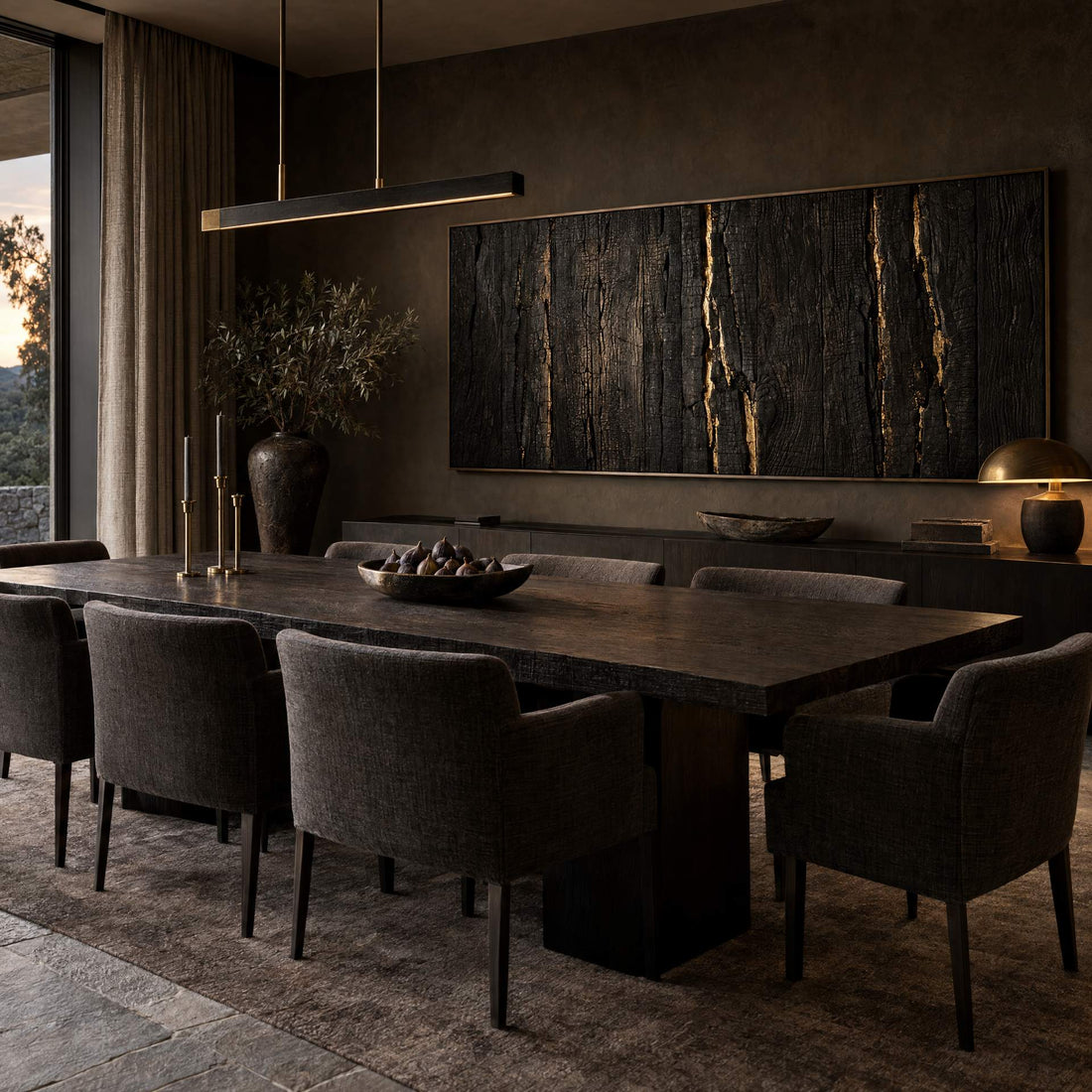 Charred timber canvas with gold veins above a dining table