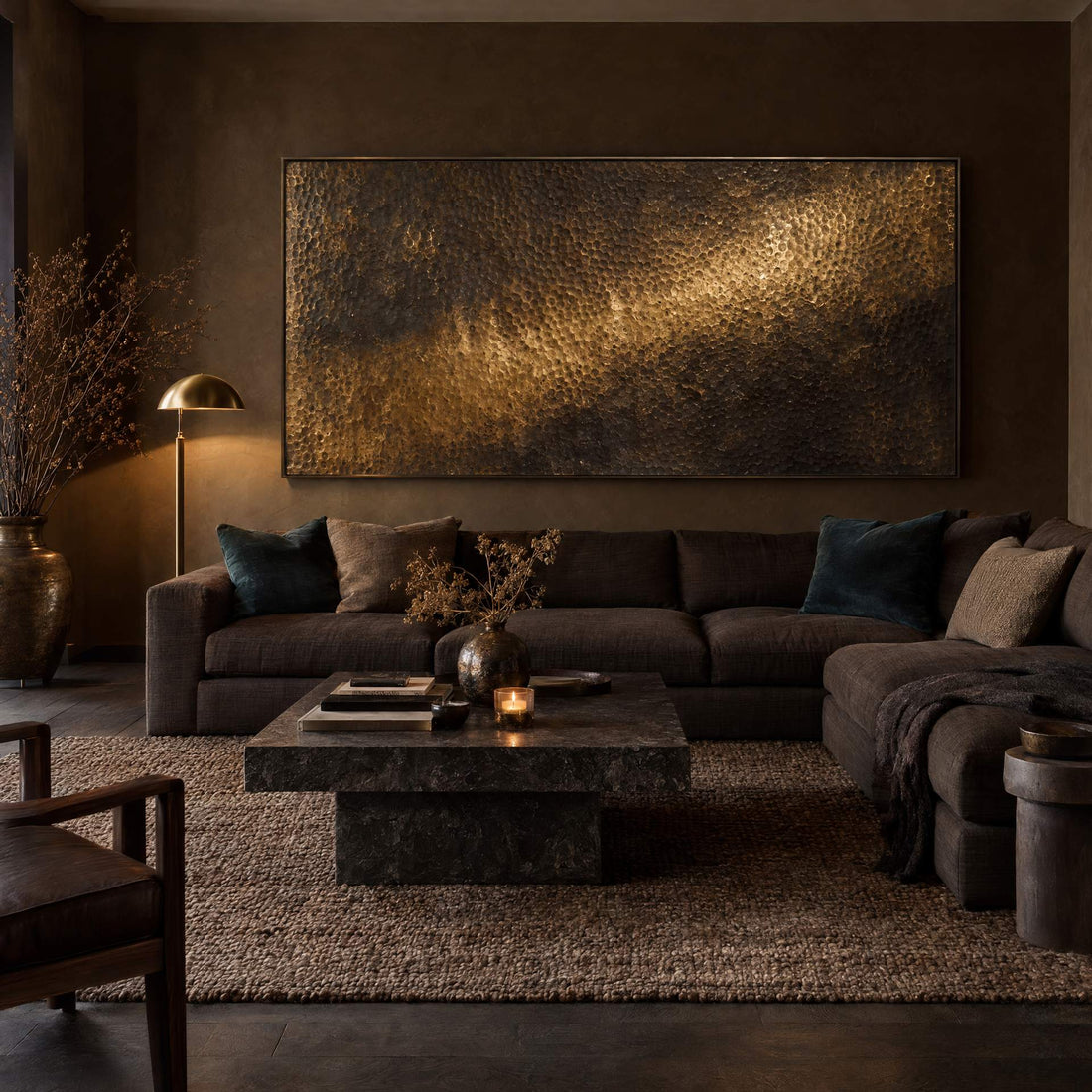 Hammered brass relief canvas above a brown sectional in a dark living room