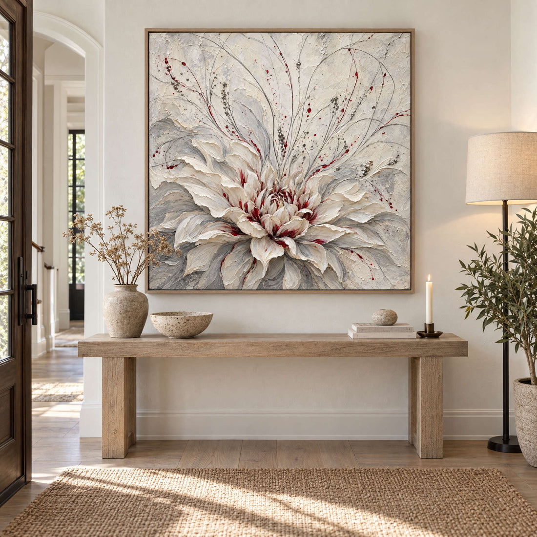 White dahlia canvas above a timber console in a bright entryway