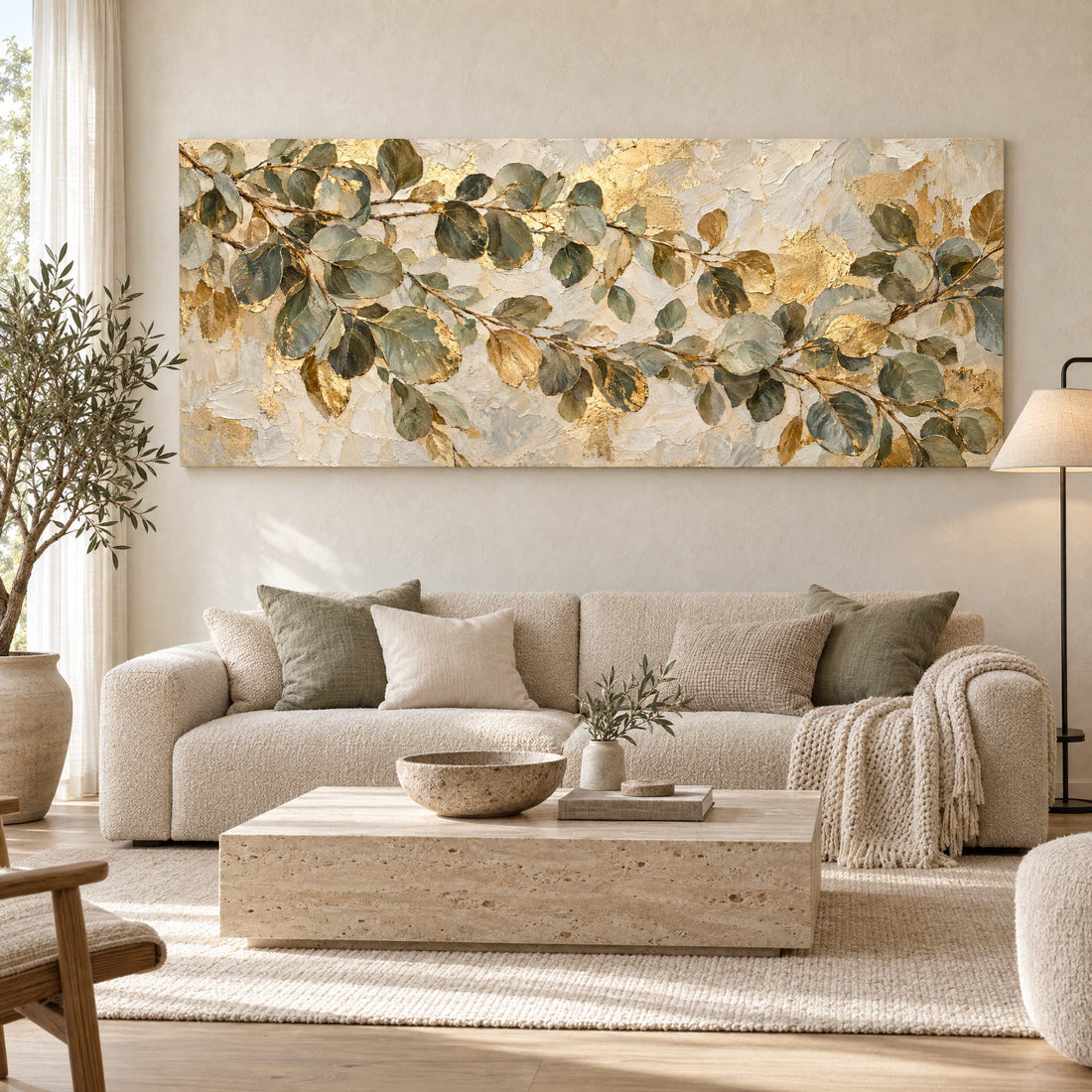 Sage green eucalyptus and gold canvas above a boucle sofa in a Japandi living room
