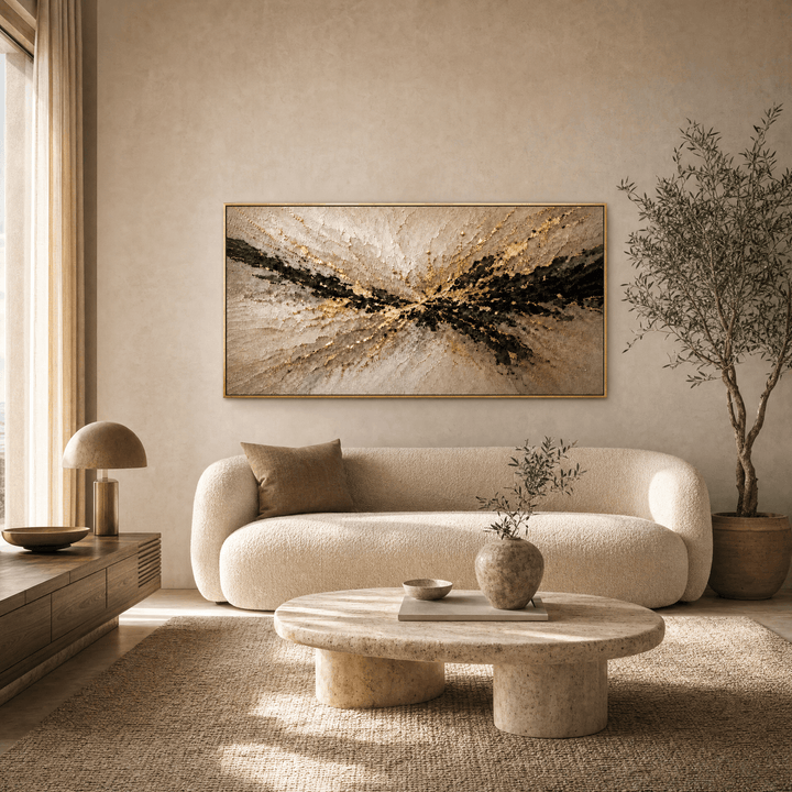 Gold and black abstract relief canvas above a curved boucle sofa in a contemporary living room