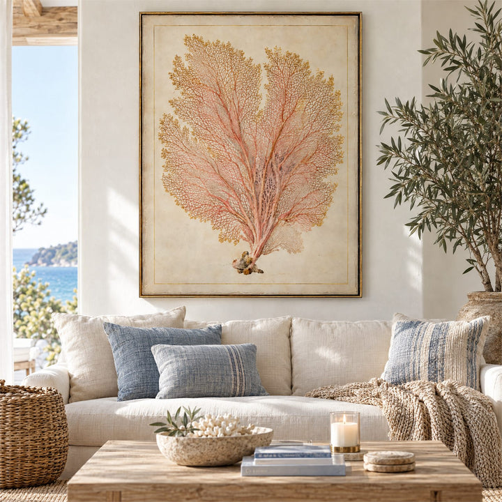 Coral pink and gold vintage sea fan botanical canvas above a linen sofa in a coastal living room