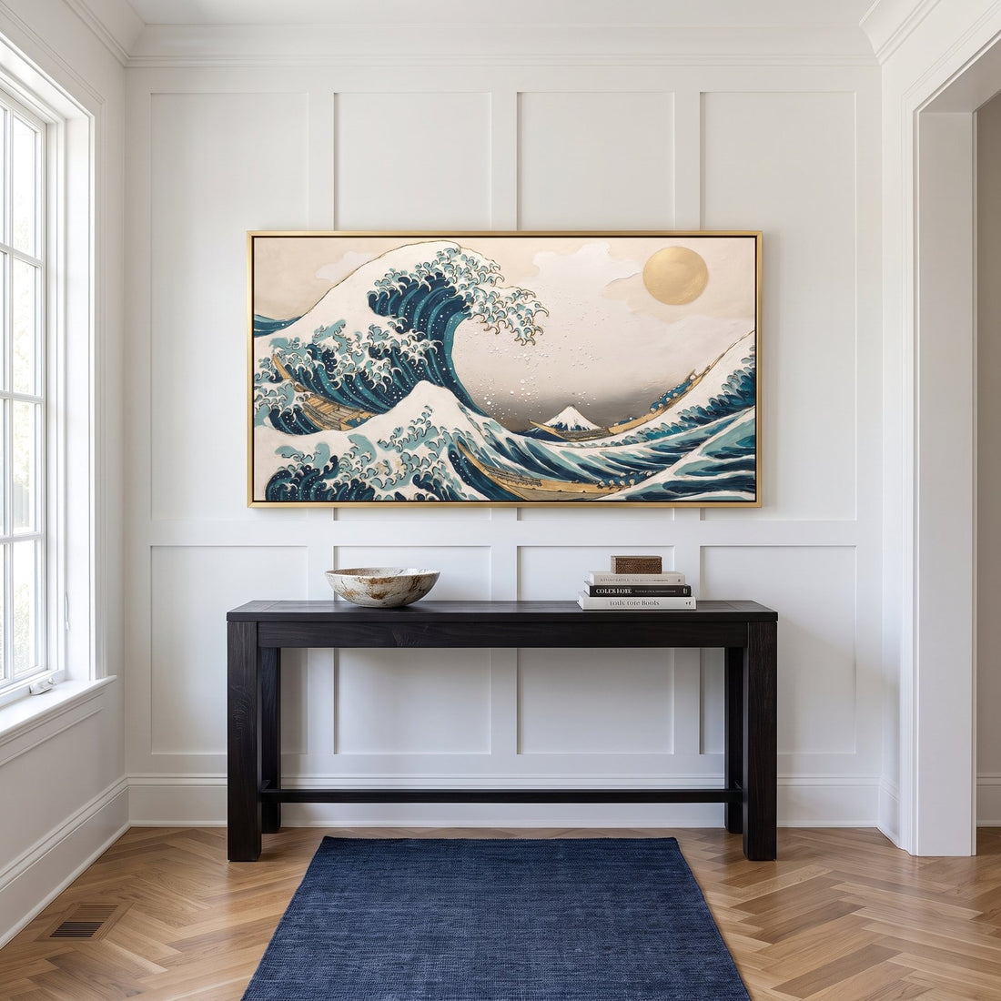 Great wave canvas above a dark console in a white panelled hallway