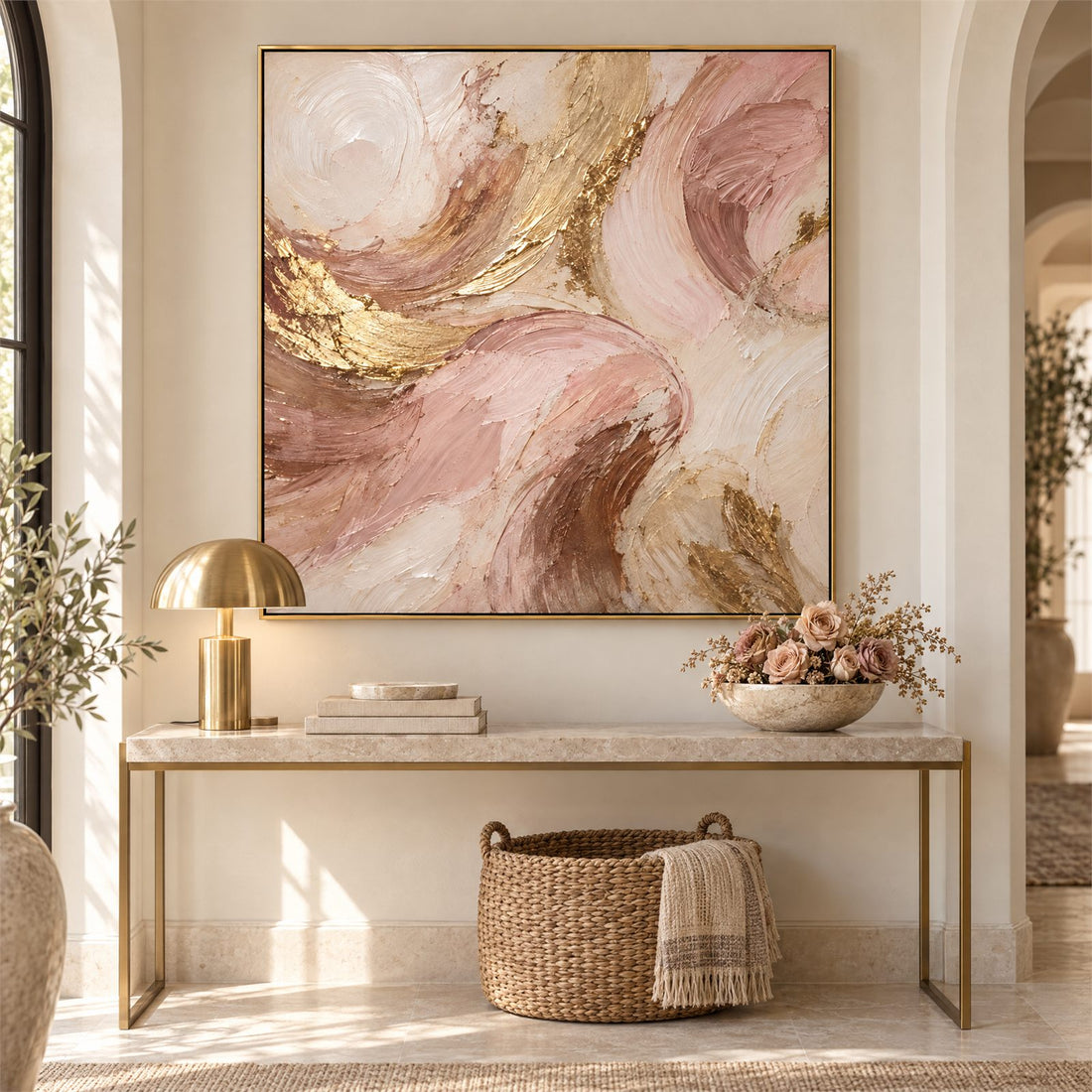 Blush and gold abstract canvas above a console table in an entryway