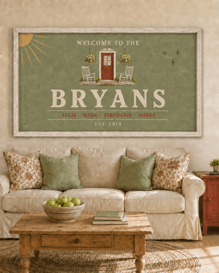 Personalized farmhouse welcome sign canvas in sage green with family surname, first names and established date, hung above a sofa