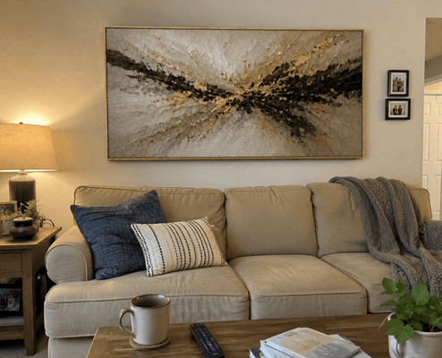 Melissa and Daniel at home with their Gilded Burst canvas hanging above the sofa