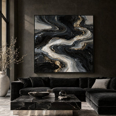 Black and silver abstract river canvas above a dark velvet sofa