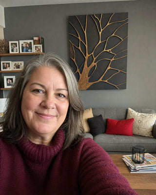 Customer in her living room with a bronze tree canvas on a grey wall
