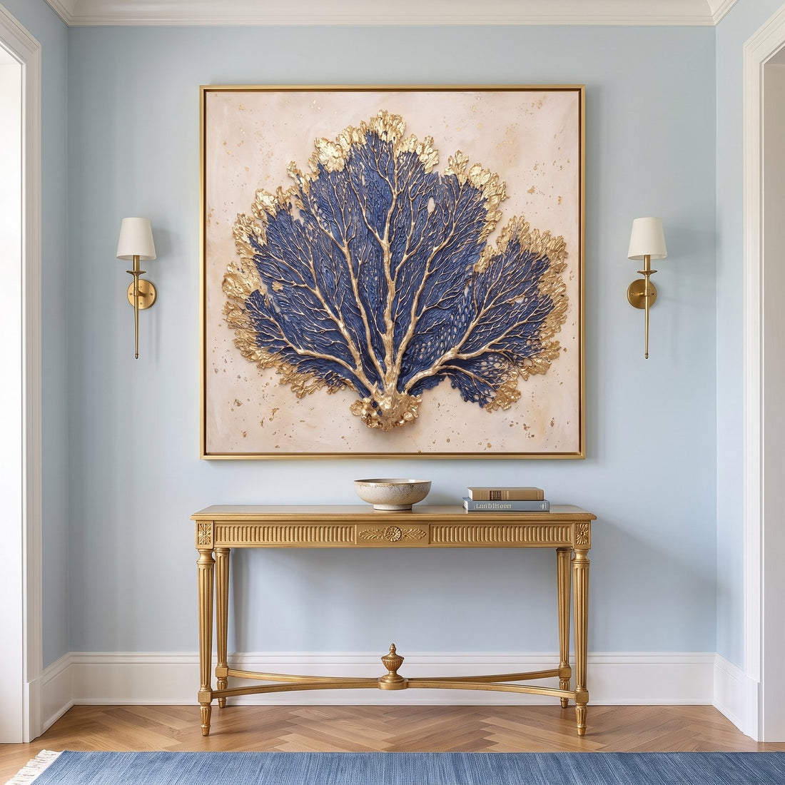 Blue and gold sea fan canvas above a gilded console in a pale blue entryway