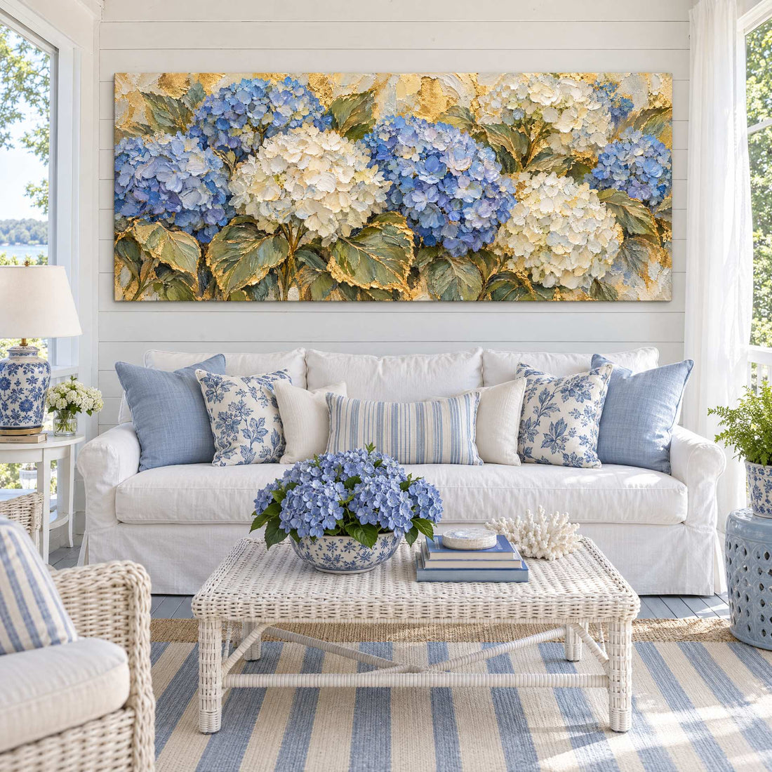 Blue and white hydrangea canvas above a white sofa on a coastal porch