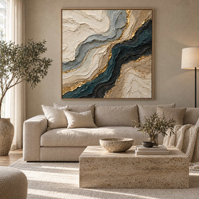 Navy and gold marbled agate canvas above a cream sofa in a warm greige living room