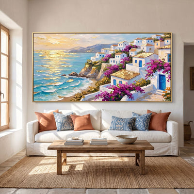 Panoramic Mediterranean village wall art above a white linen sofa