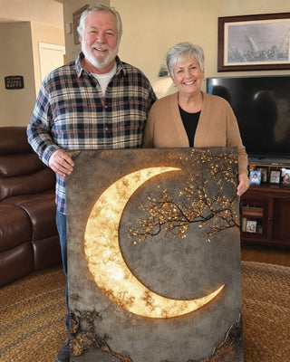 Customer couple holding their Luxury Crescent Moon canvas in their living room