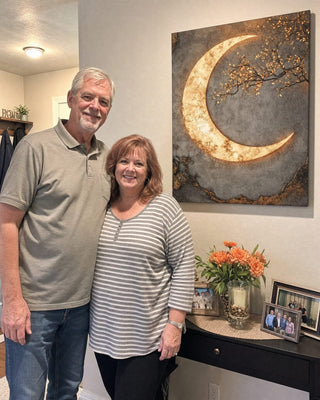 Customer beside her framed Luxury Crescent Moon canvas in her kitchen