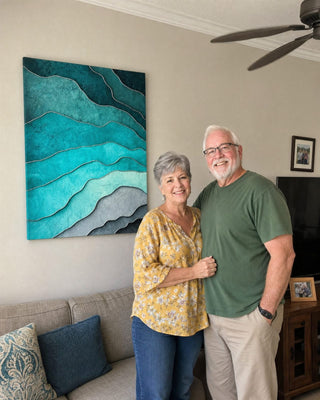 Customer couple beside a teal layered ocean canvas in their living room