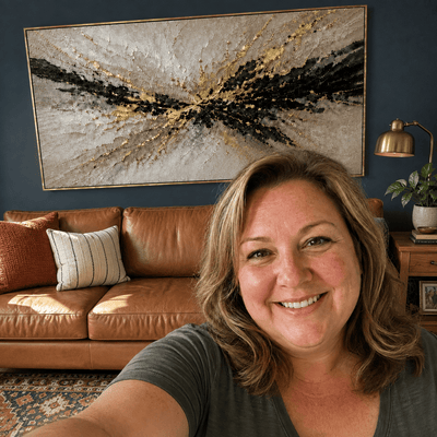 Jennifer M. at home with her Gilded Burst canvas hanging above the sofa