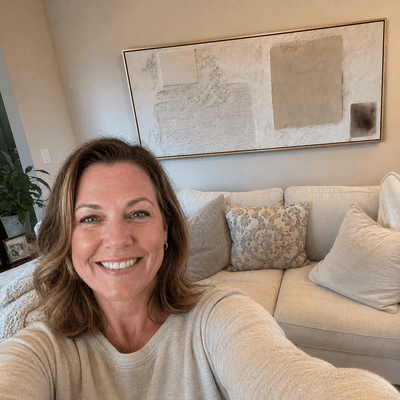 Michelle R. at home with her Minimalist Plaster canvas hanging above the sofa