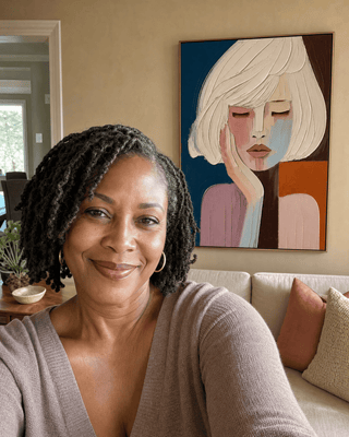 Janice Brown at home with her Quiet Reverie canvas hanging above the sofa