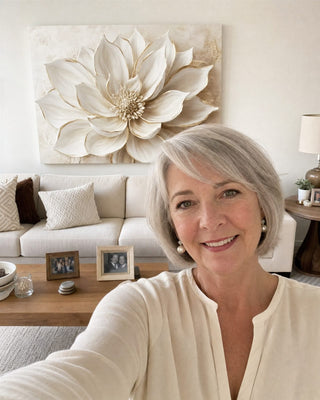 Customer in her living room with a white and gold floral canvas above the sofa